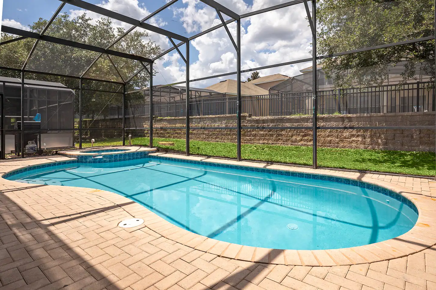 You have your own private screened-in pool and spa, along with a basketball hoop and lounge chairs.