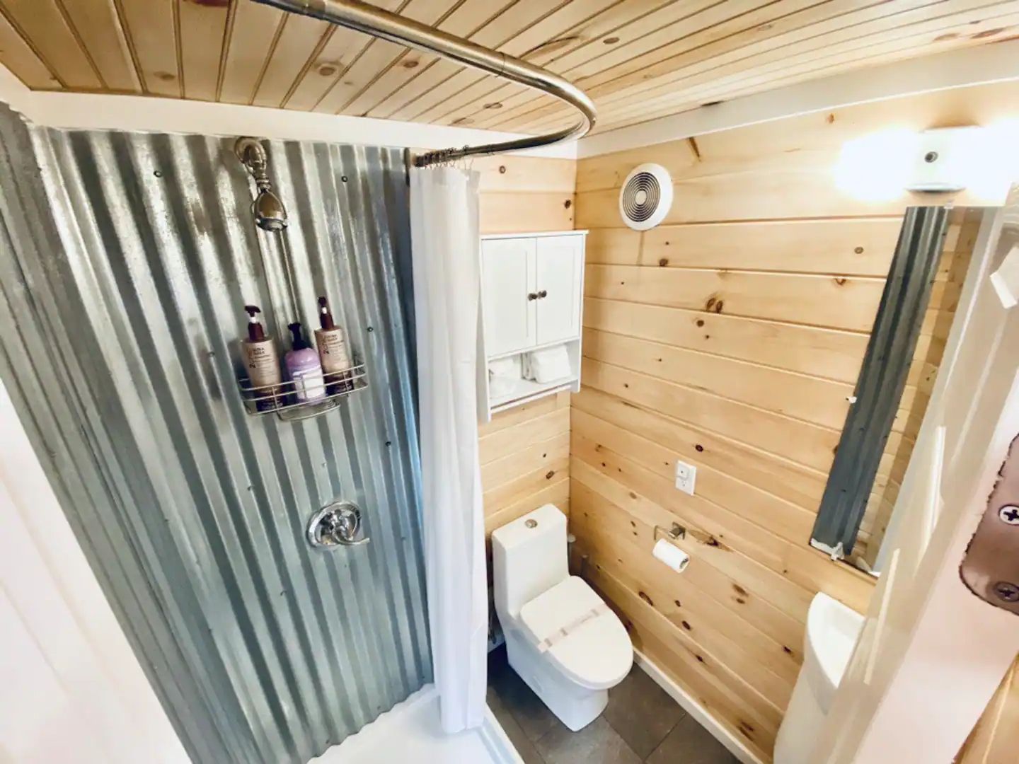 Shower, tiny sink, fluffy cotton towels, and high-end amenities in a custom bathroom