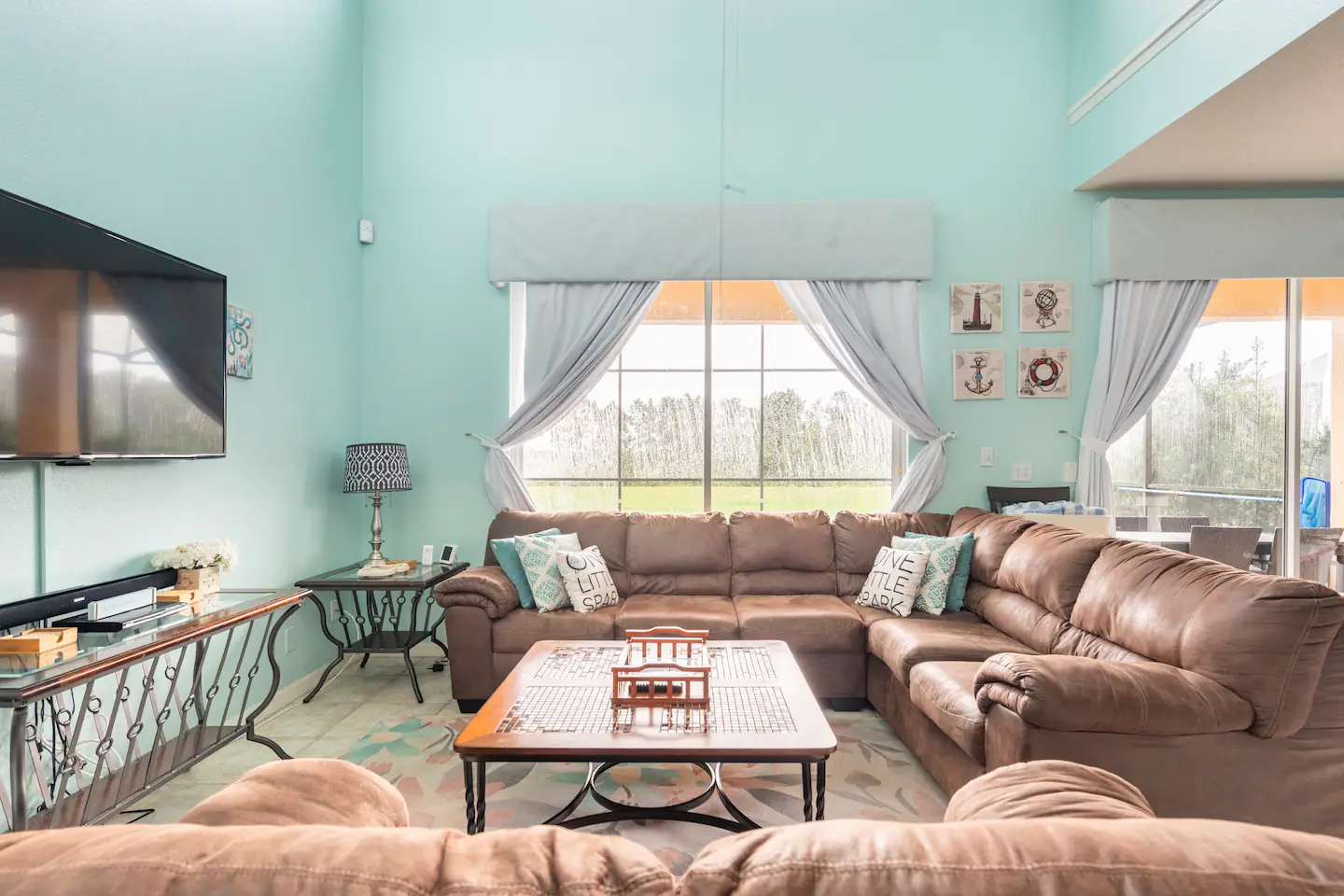 A living room with flat screen TV and can accommodate large groups of people.