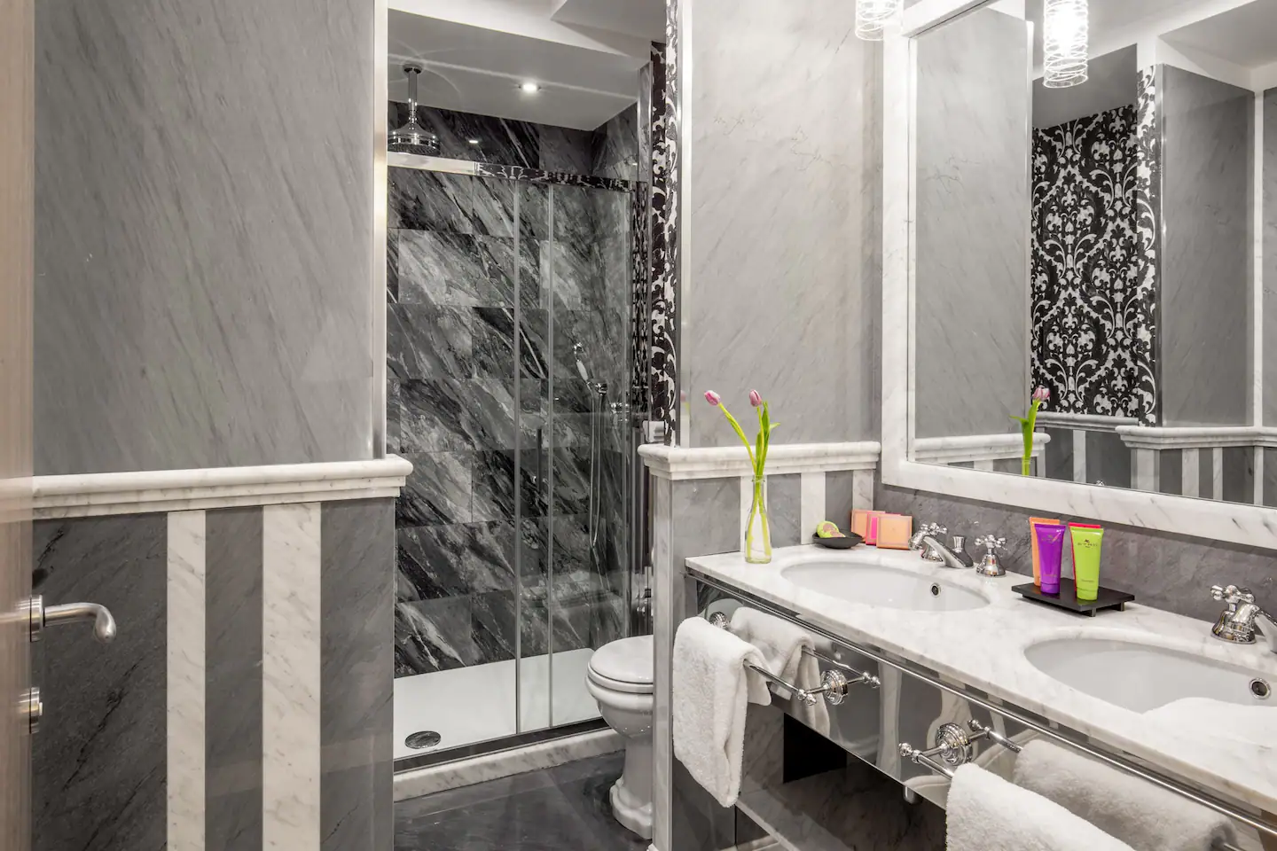 A fully equipped bathroom with a bathtub, shower, sink, and toilet, offering a clean and relaxing space for personal care routines.