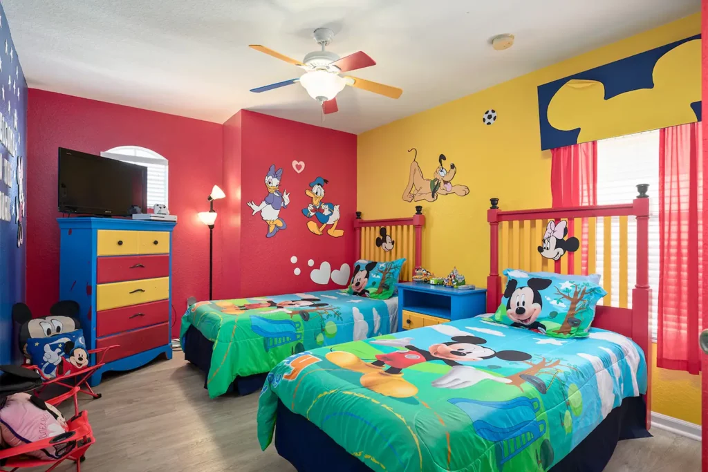Mickey and Friends decorated children's bedroom with twin beds, 32-inch television, XBOX One with Kinect, and XBOX games
