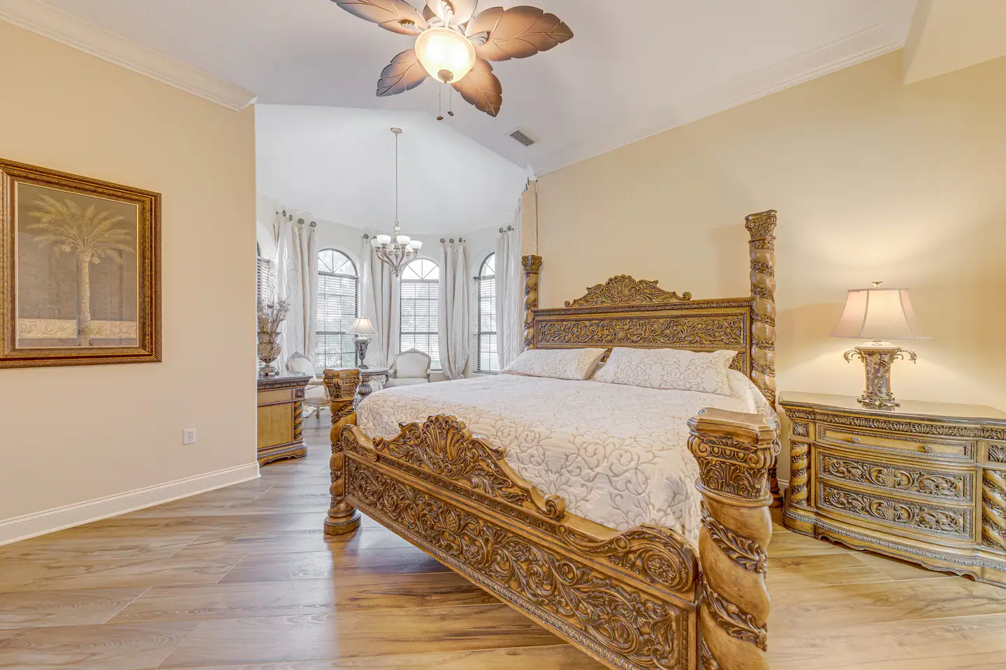 King bed with lounge area, walk-in closet, and walk-in shower.