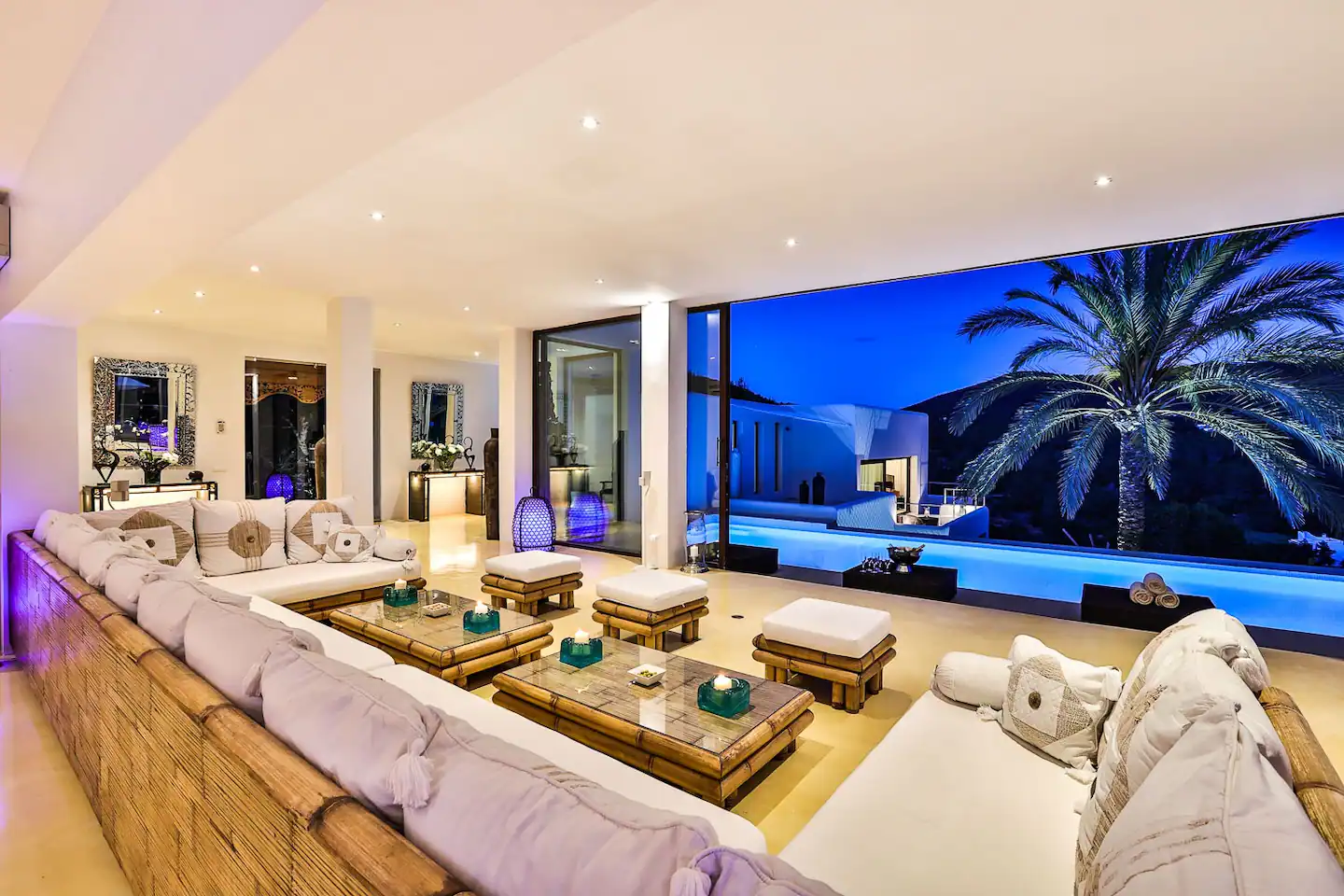 The living room offering a picturesque view of the inviting pool and serene outdoor landscape.