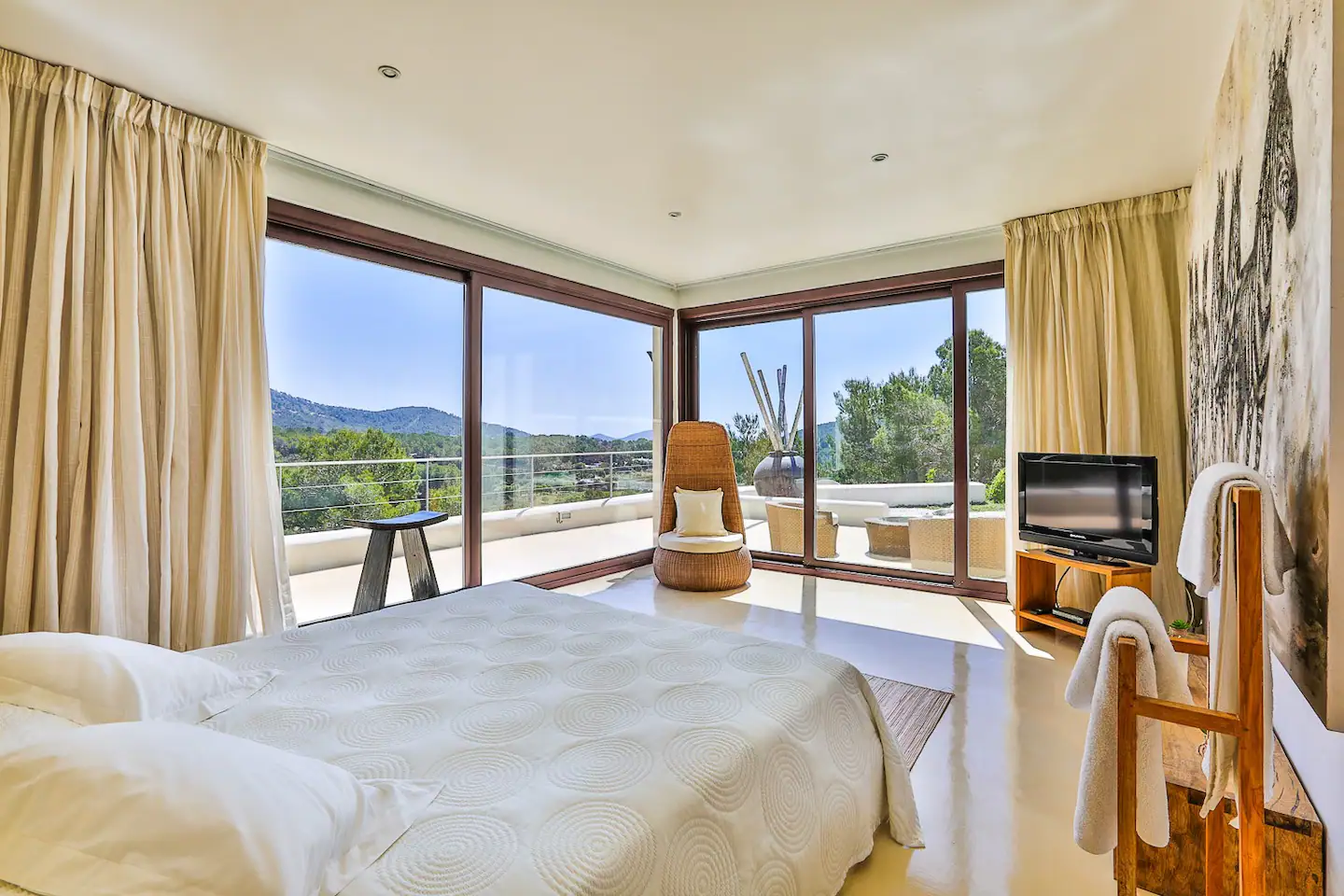 A warm and inviting bedroom featuring a plush bed, soft lighting, and tasteful decor, creating a cozy ambiance.