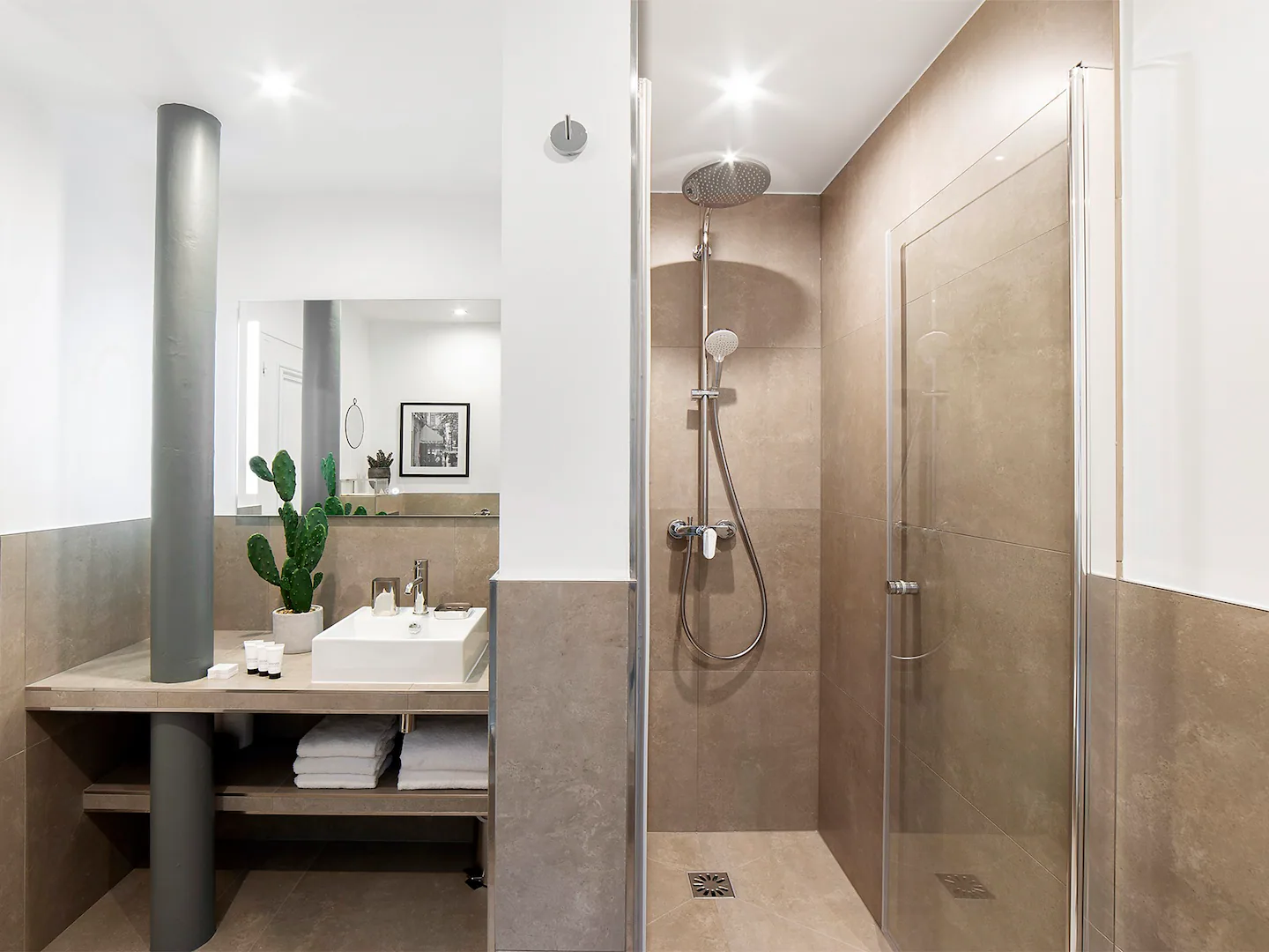 First full bathroom with walk-in shower, toilet, sink and towels