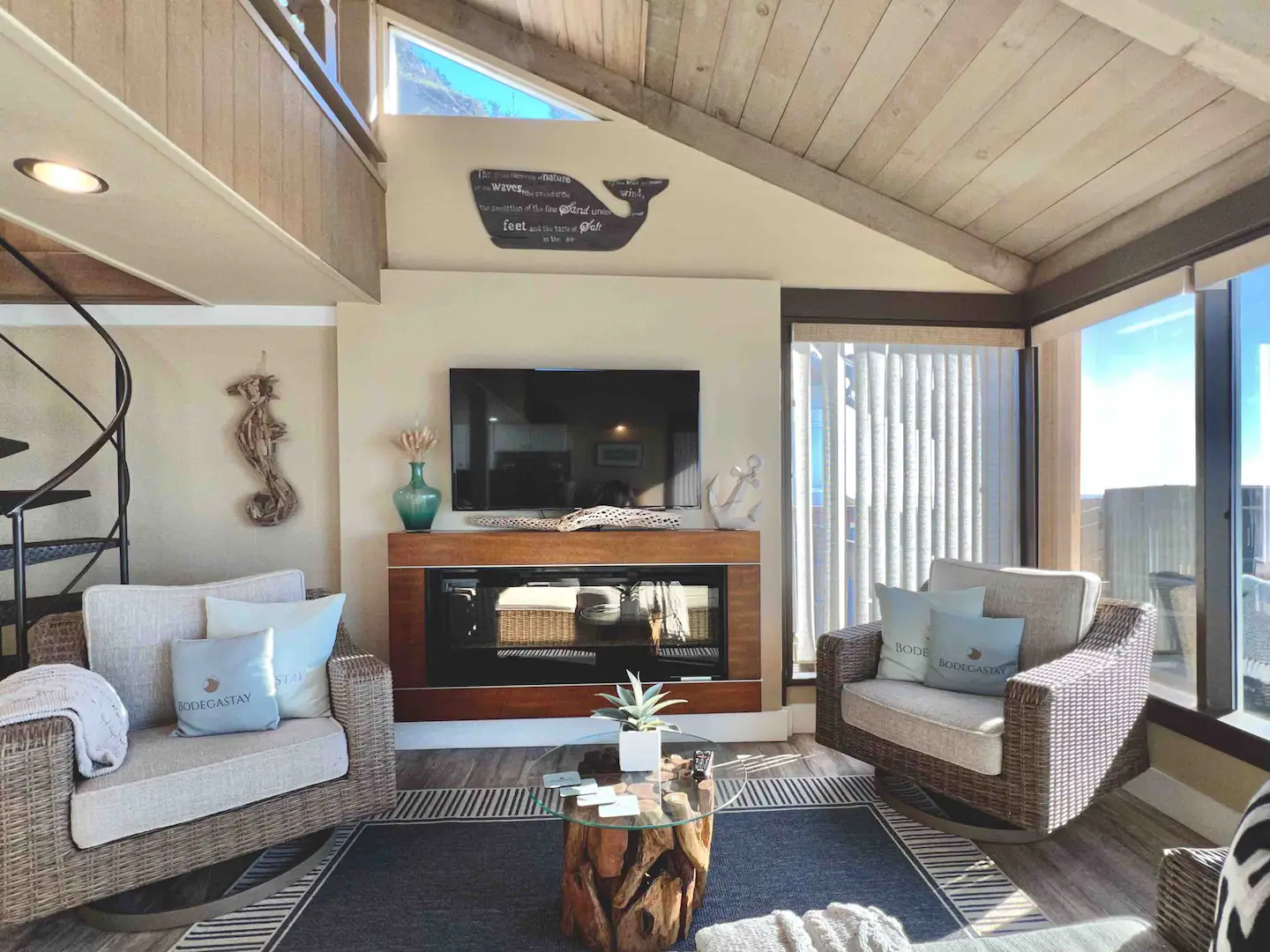 The great room with it's 20 foot wide wall of pacific facing windows is comfortably furnished with a beautiful glass pebble, flame effect fireplace and a wall mounted flat screen T.V. & Internet.