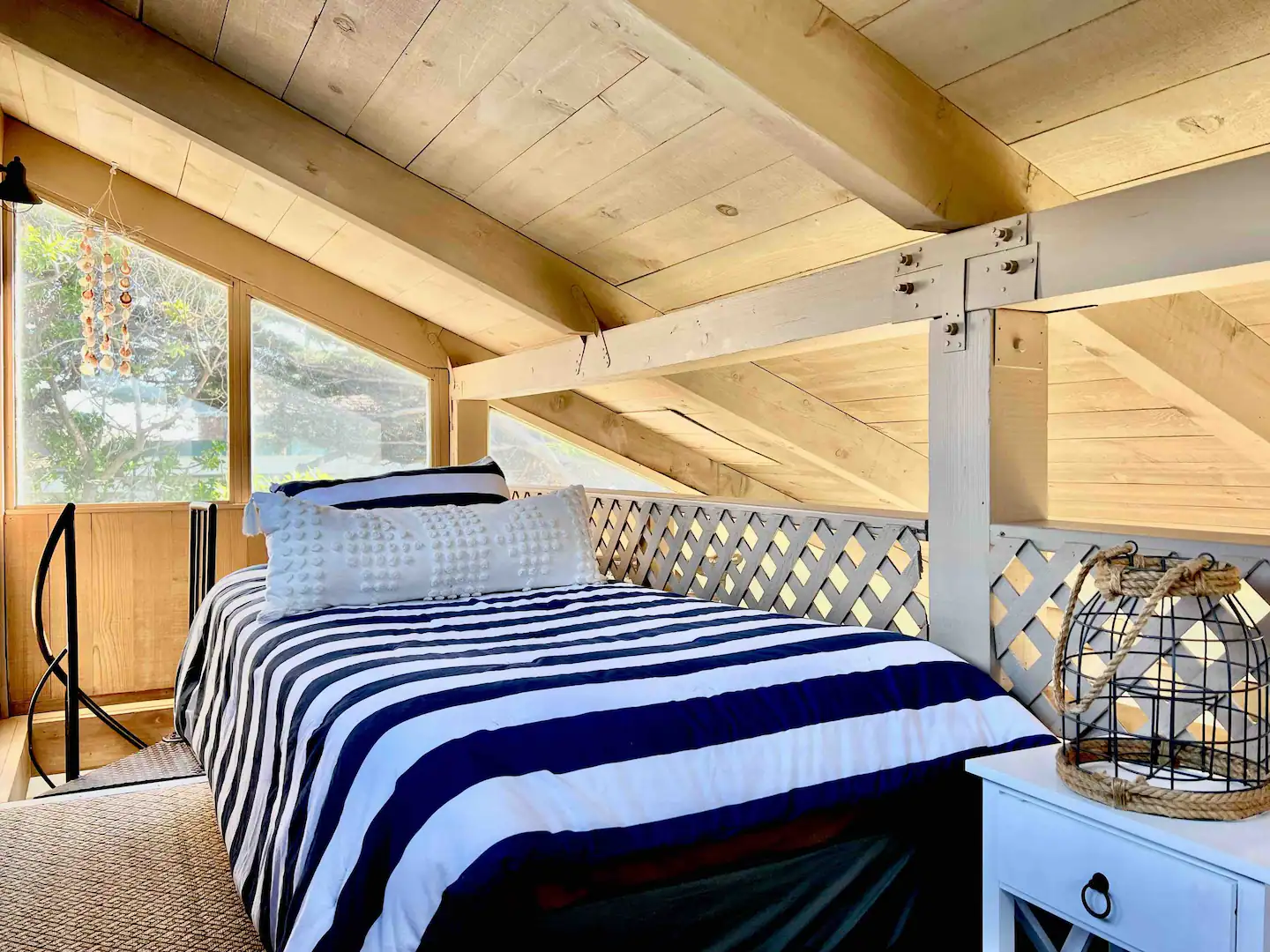 The design and construction team have kept the integrity of the seaside property with it's spiral staircase up to the loft, raked ceiling and coastal decor enhancing the beach house ambiance.