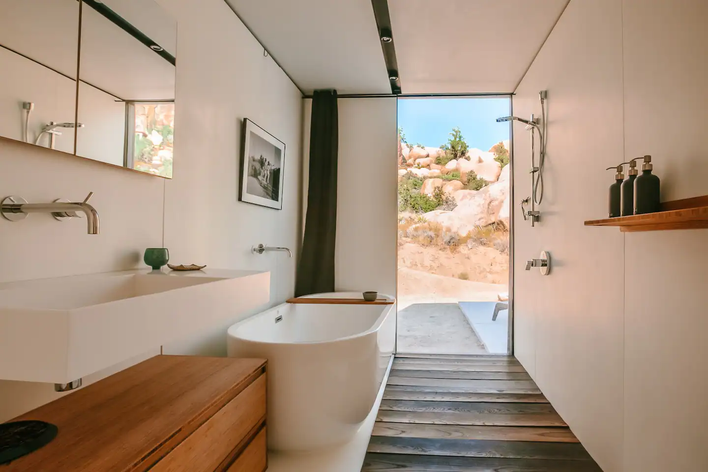 Evening bathing in the primary en suite with a view of the boulders and stars.