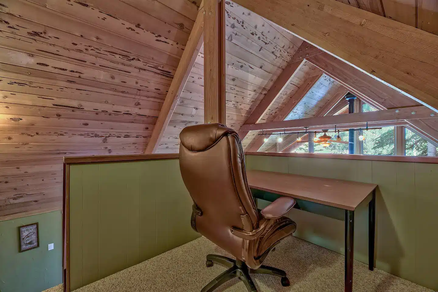 Small office area with relaxing chair and a desk.