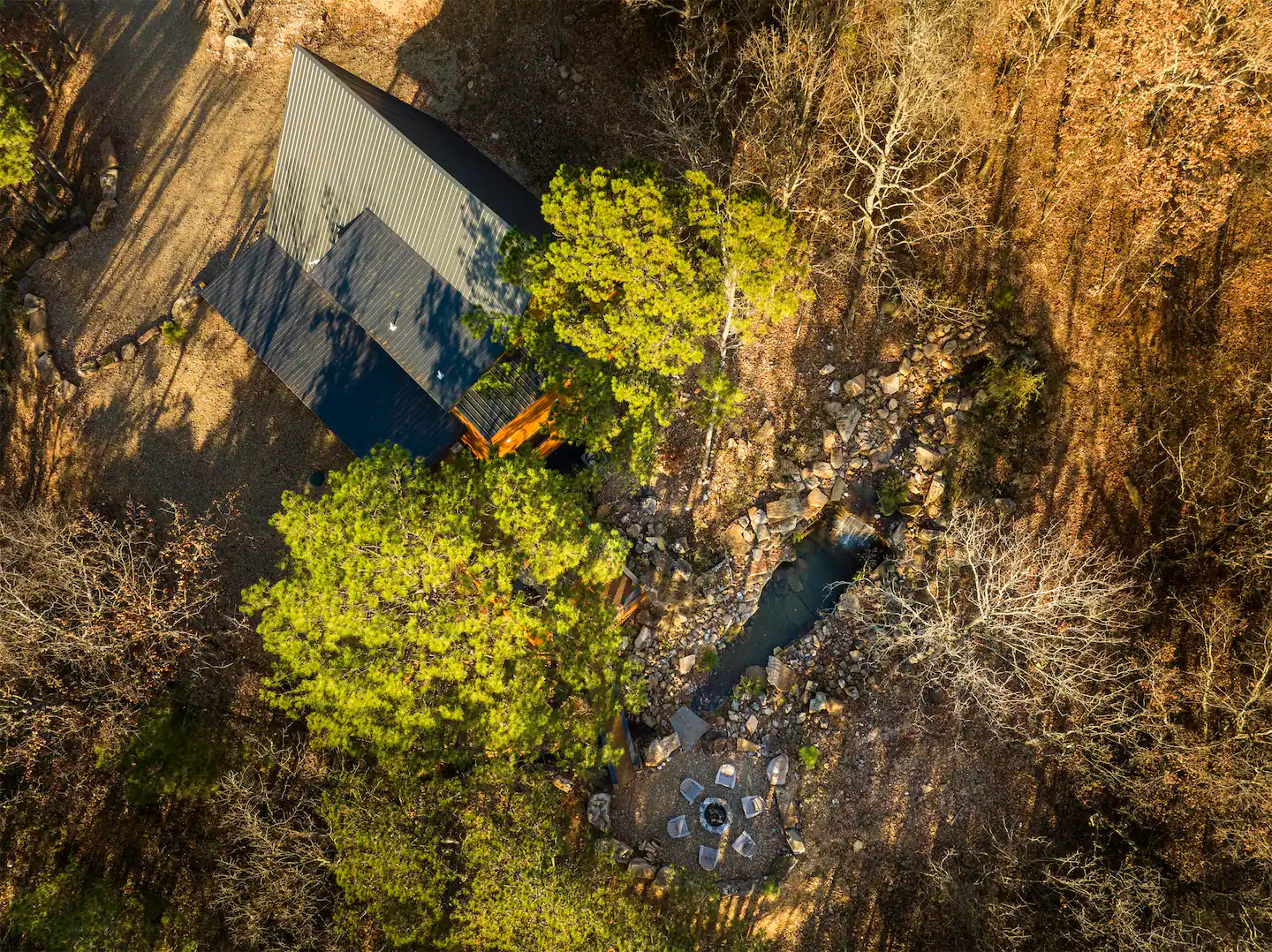 Here's an aerial in the fall where you can see the waterfall, and fire pit area behind the cabin!