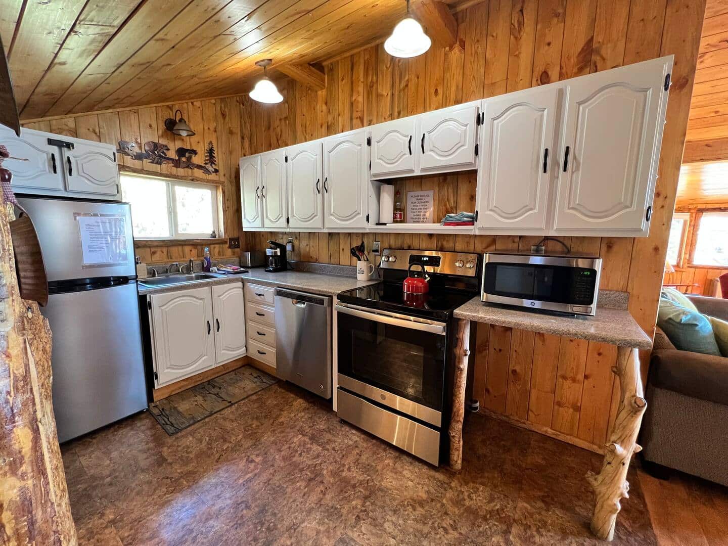 The kitchen is fully stocked with utensils, small appliances, fridge, freezer, full size oven and stove, microwave, drop coffee maker, toaster, and more.