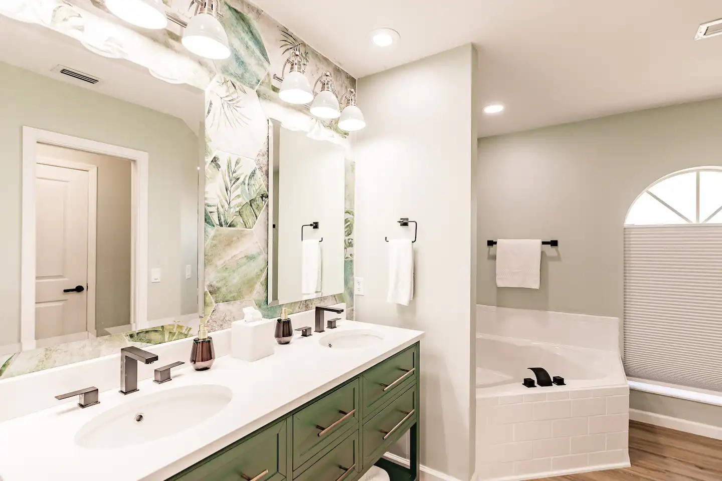 En suite bathroom to primary bedroom with double vanity, soaker tub and walk-in shower.