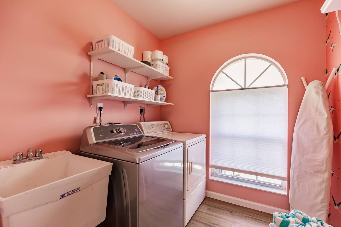 Full laundry room with detergent, extra paper products and cleaning supplies.