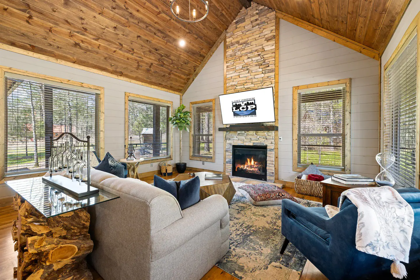 The spacious living room consist of vaulted ceilings, a gas fireplace and a sixty-five-inch smartTV with Bluetooth sound bar.