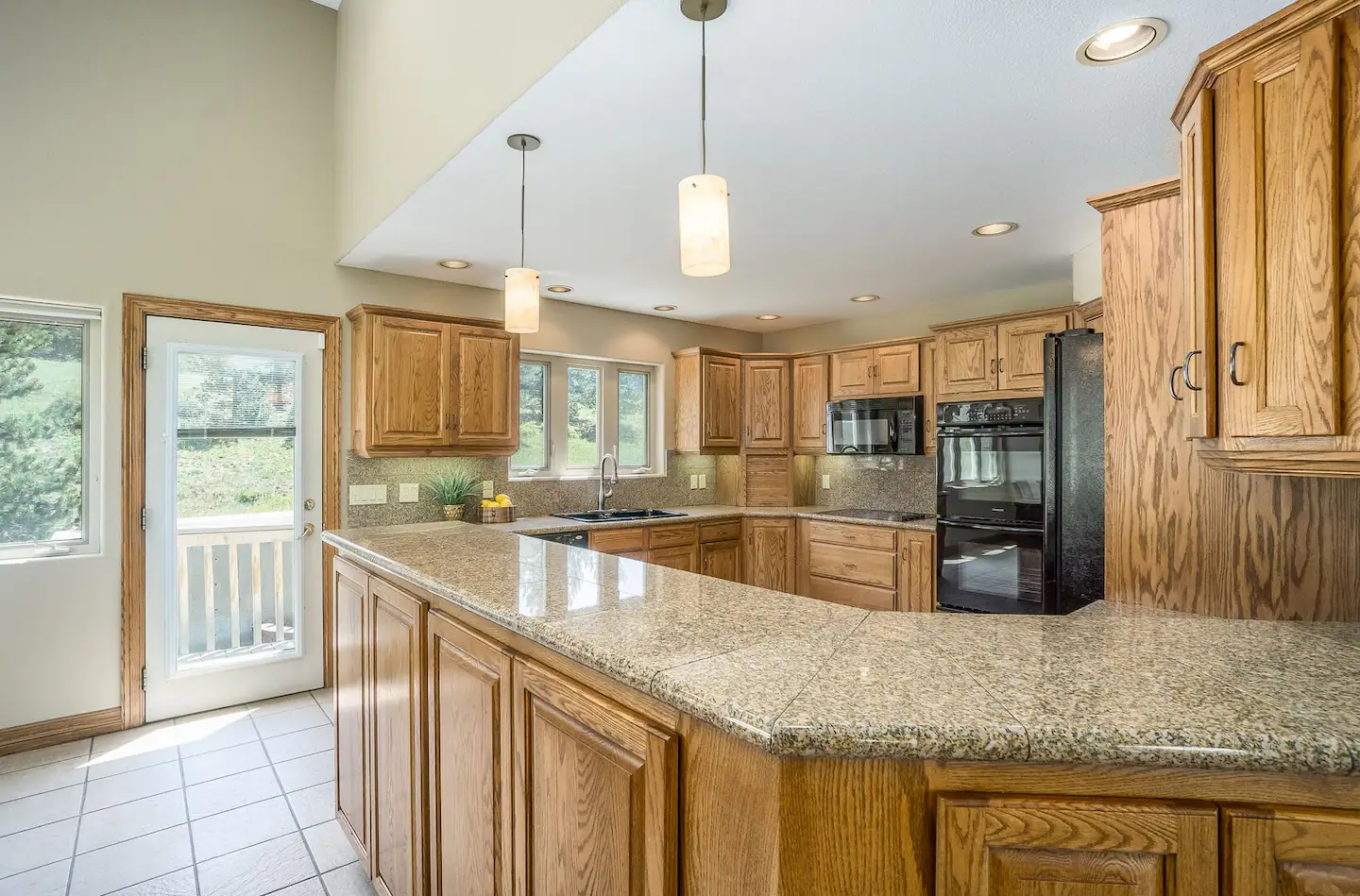 Kitchen oven, microwave and stove top.
