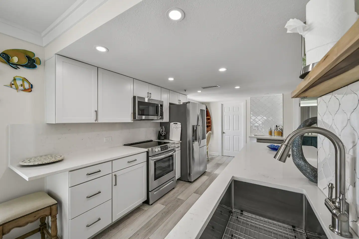Kitchen fully equipped with appliances.